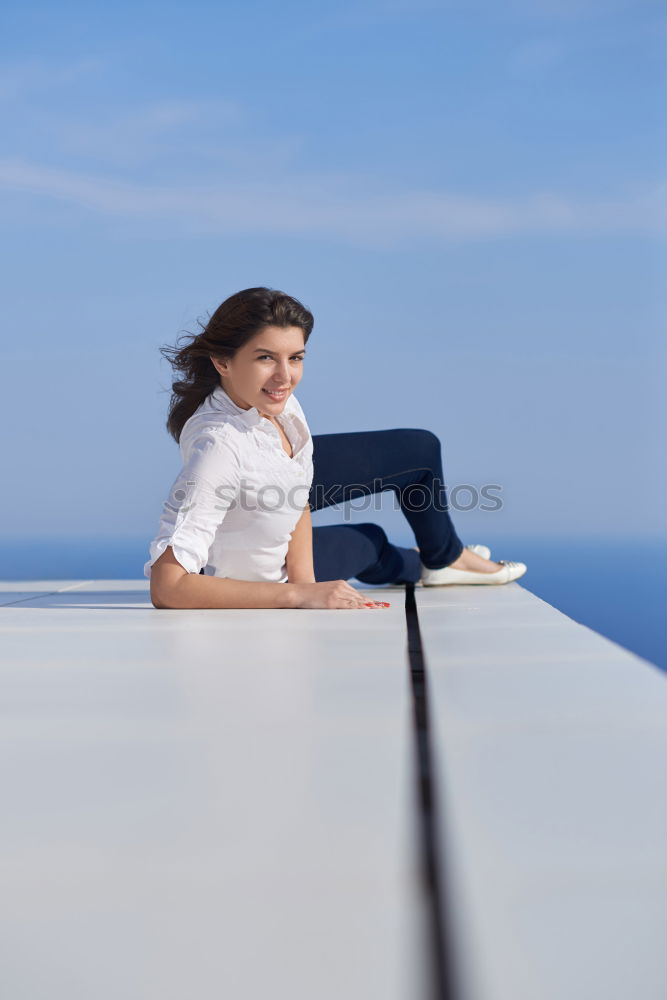 Similar – Woman barefoot sitting on roof of car