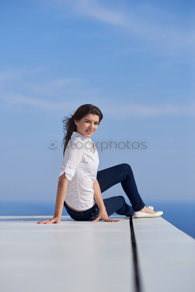 Similar – Woman barefoot sitting on roof of car