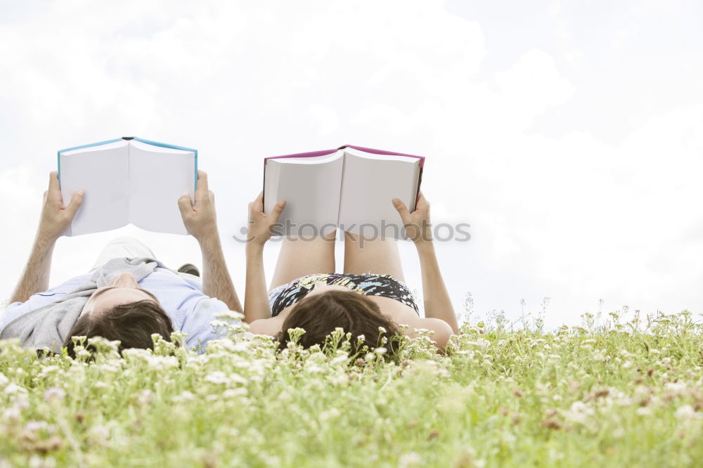 Similar – Image, Stock Photo Girl lying on a blanket and reading a book on a sunny day