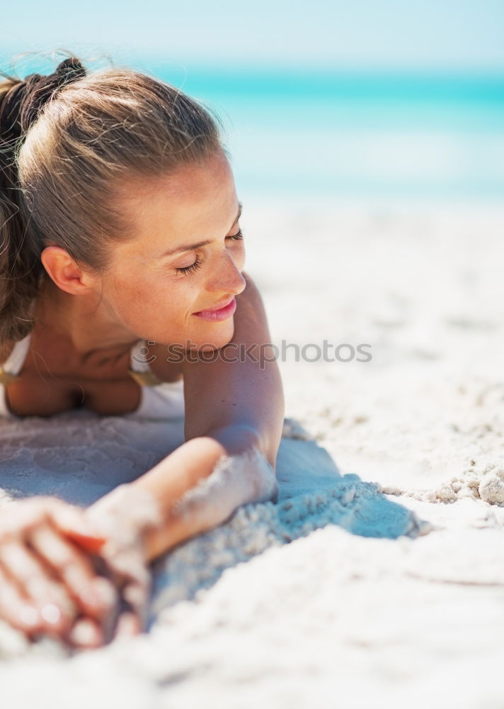 Similar – Woman in bikini sitting on bench near water