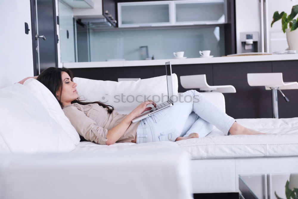 Similar – woman with laptop on her sofa at home