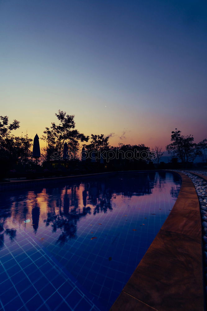 Similar – Image, Stock Photo Pool, sunbeds and umbrellas at night. Night lights.