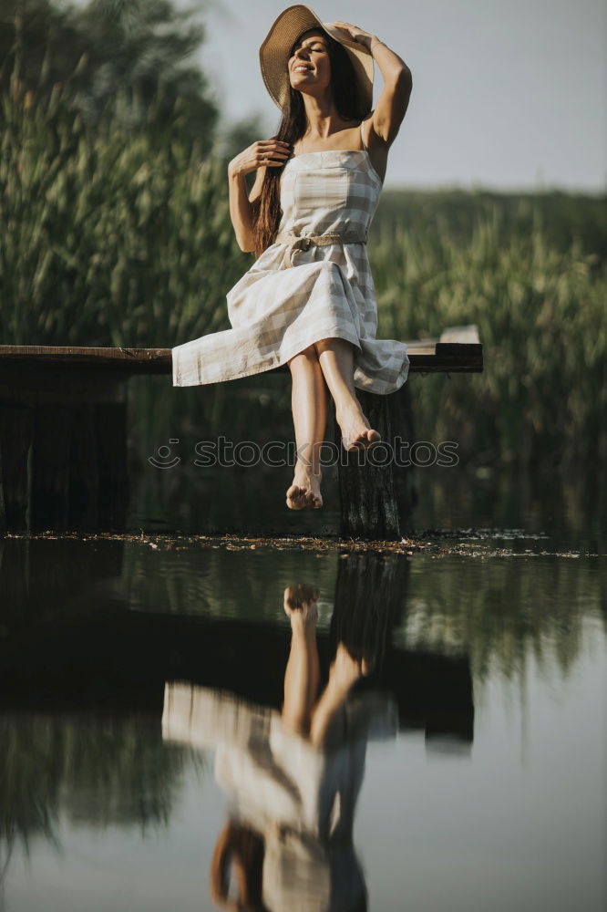 Similar – Image, Stock Photo Portrait of a young blonde woman in a white summer dress in a lake on the surface