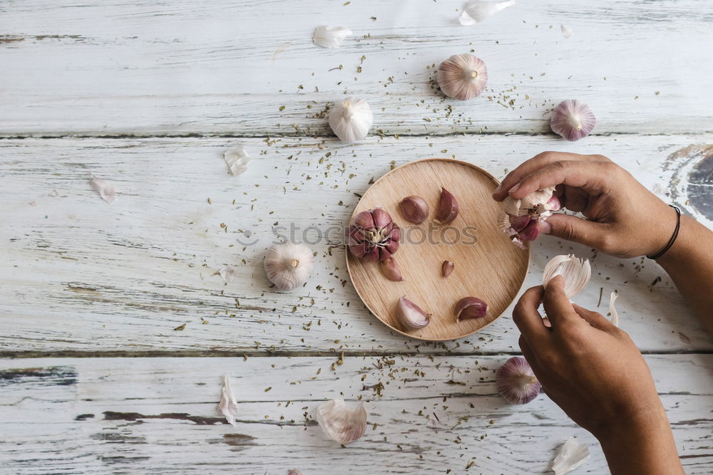 Image, Stock Photo Removing the grains of a head of garlic