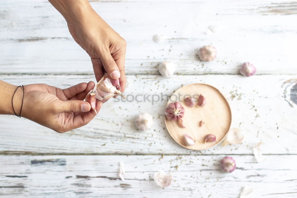 Similar – Image, Stock Photo Removing the grains of a head of garlic