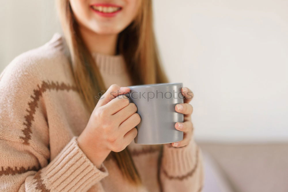 Similar – Happy young woman holding a cup of tea or coffee