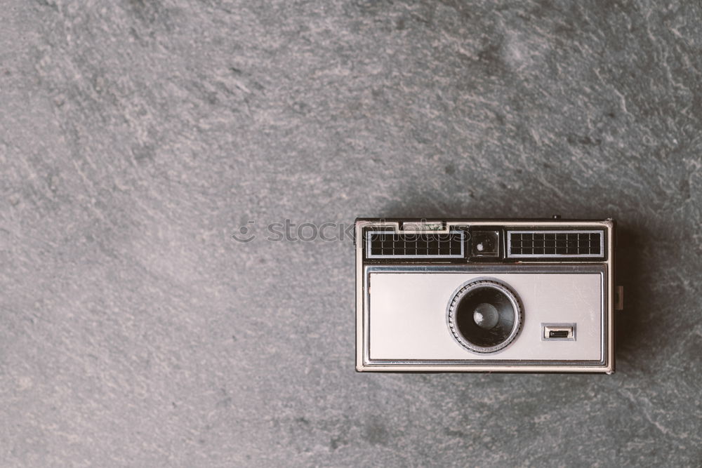 analogue 35mm camera on brown wooden table