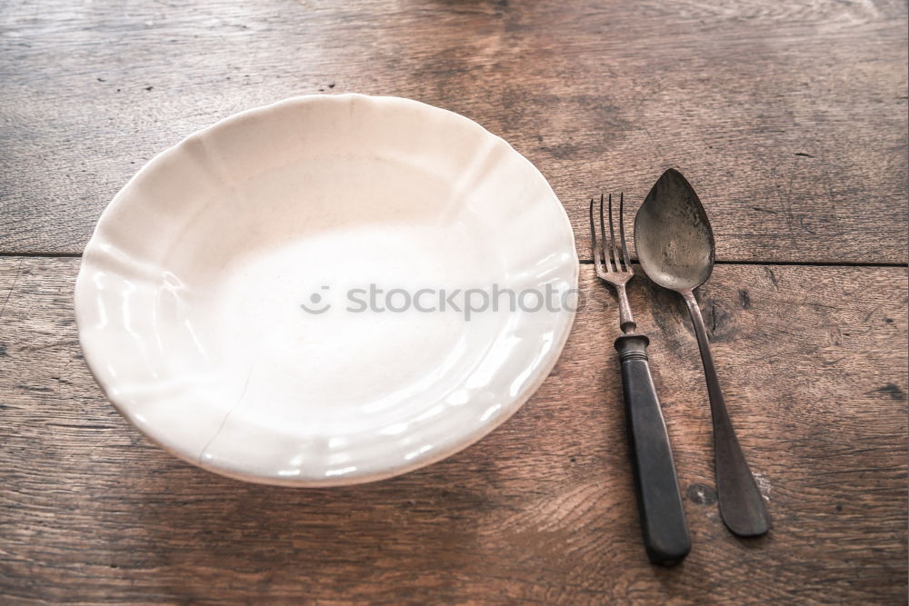 Similar – White empty plate and metal vintage knife and fork