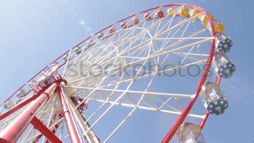 Similar – Der Blick hinauf zu einem Riesenrad mit blauem Himmel dahinter.