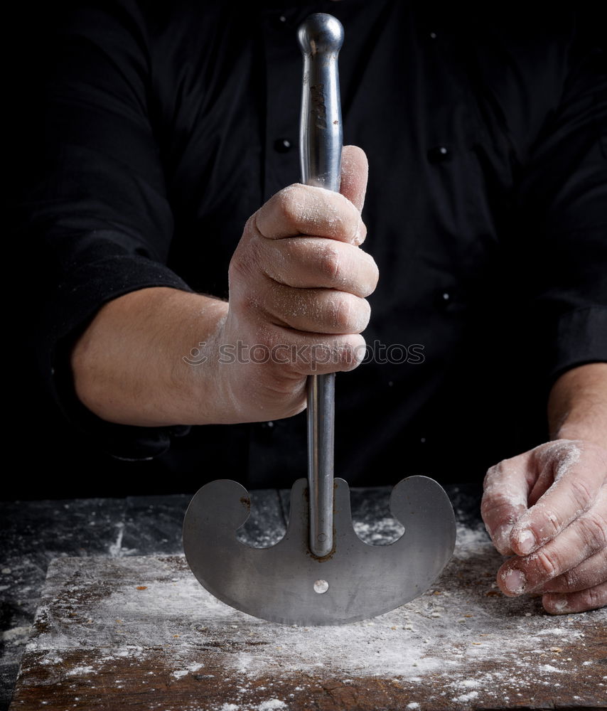 Similar – man sifts white wheat flour through a wooden sieve