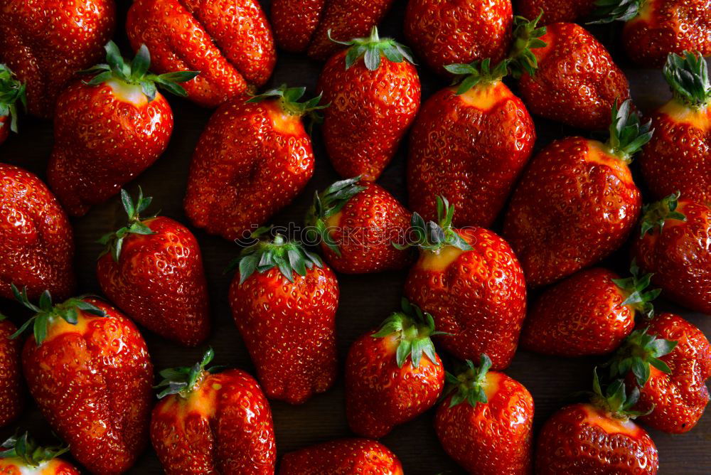 Similar – red strawberries with green stems in sale trays