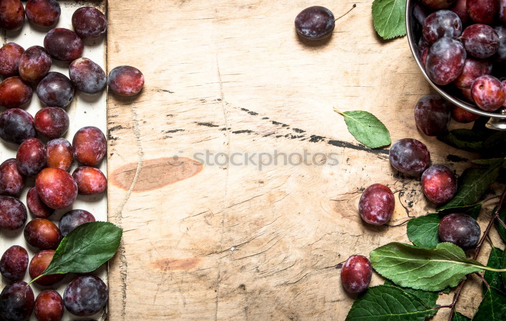 Image, Stock Photo Red grapes on an old wooden table close up