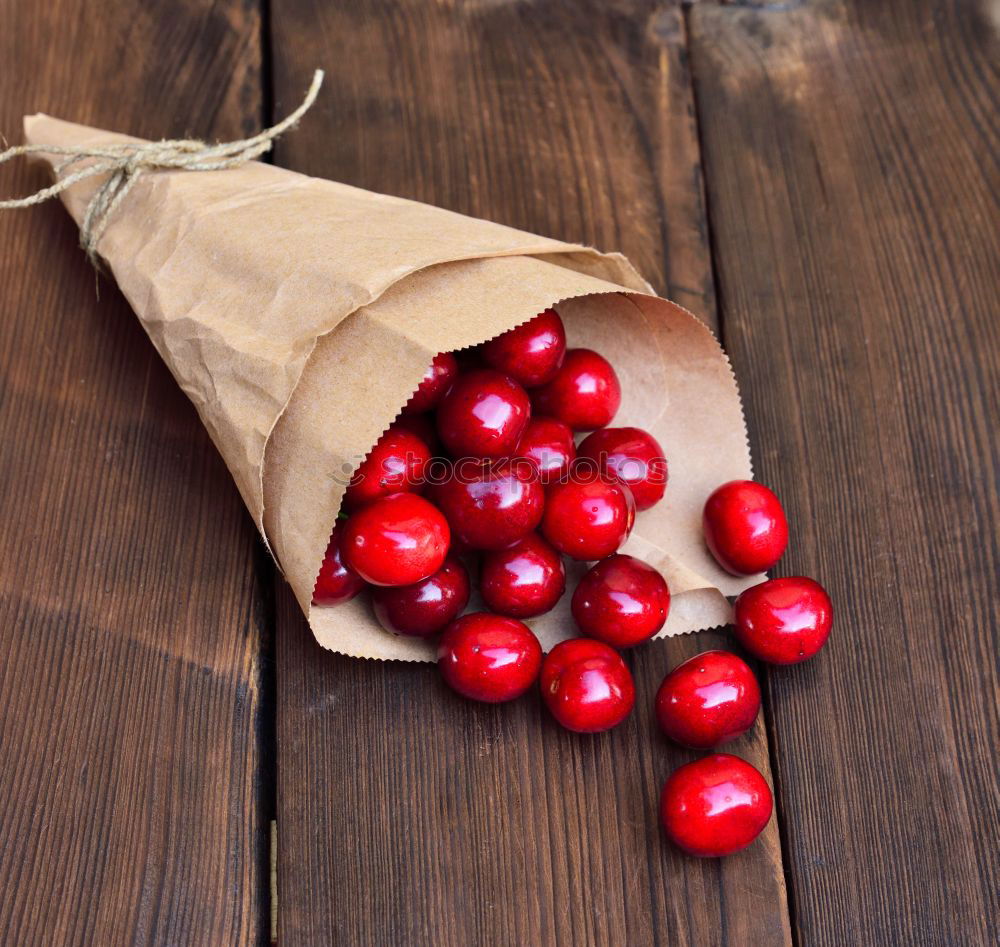 Similar – Image, Stock Photo Ripe red cherry in a paper bag