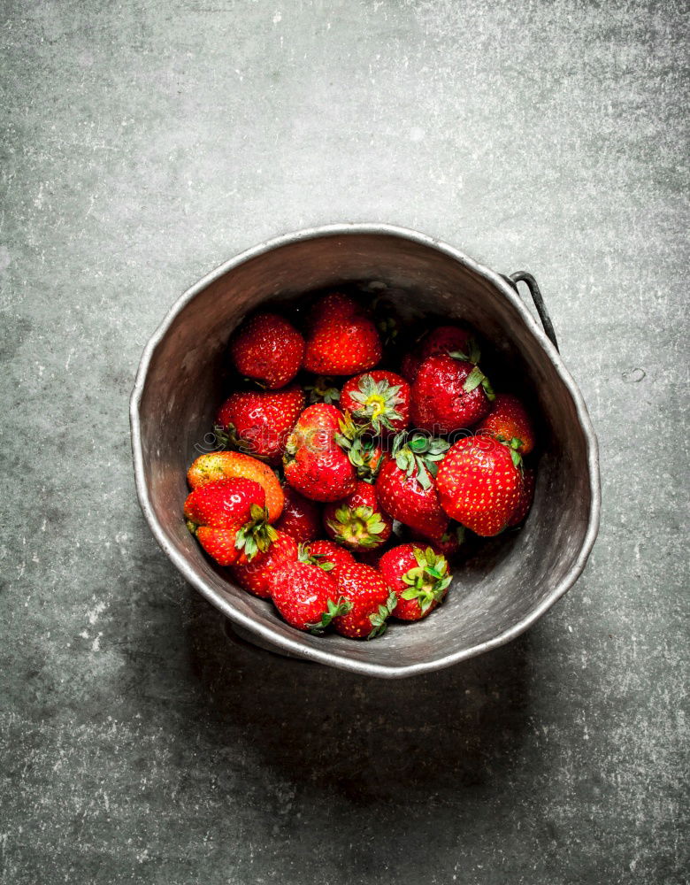 Image, Stock Photo Tasty strawberries in black colander bowl on dark rustic kitchen table. Copy space. Seasonal organic food. Healthy eating and cooking