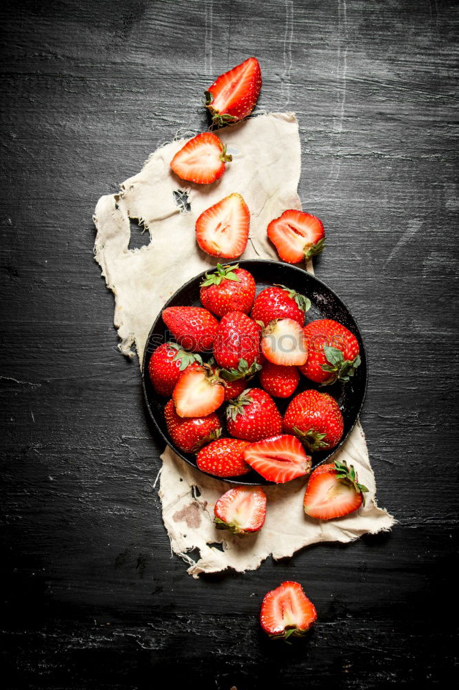 Similar – Image, Stock Photo Tasty strawberries in black colander bowl on dark rustic kitchen table. Copy space. Seasonal organic food. Healthy eating and cooking