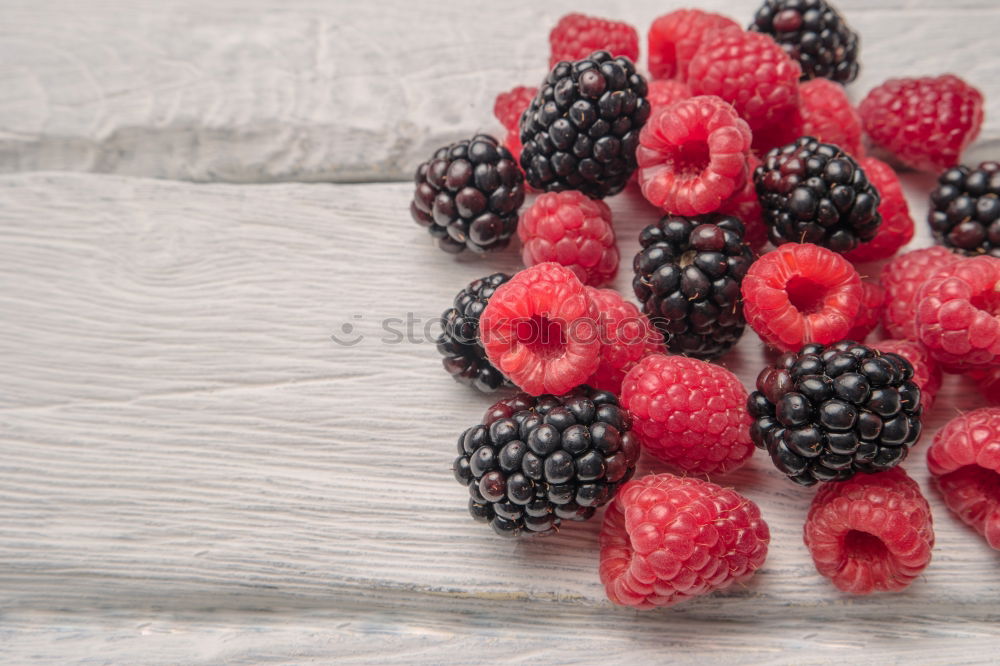 Similar – Image, Stock Photo Red and black raspberry and blueberry