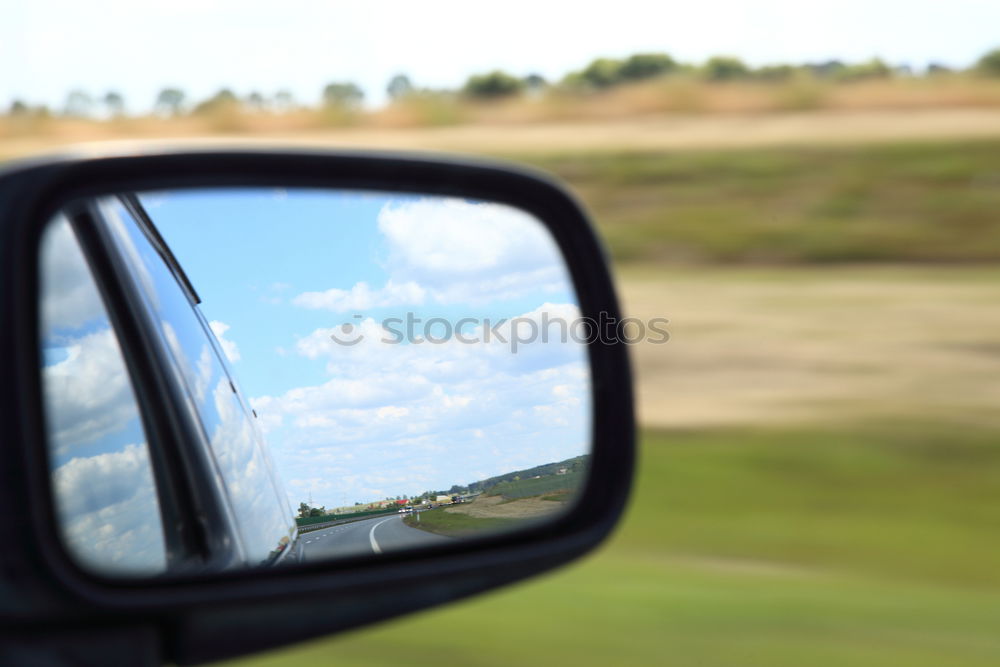 Similar – Image, Stock Photo Sunny car ride. View through the windshield onto the highway. Eyes and glasses of the driver as reflection in the rear view mirror.