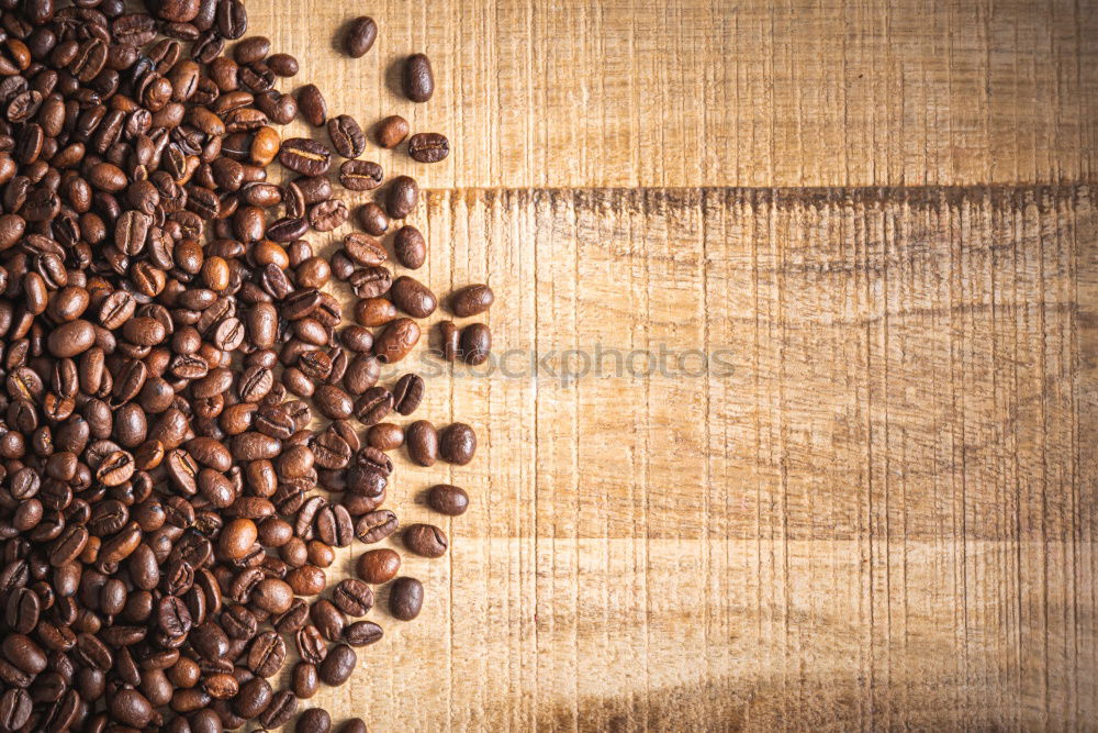 Similar – Coffee beans on wooden table background