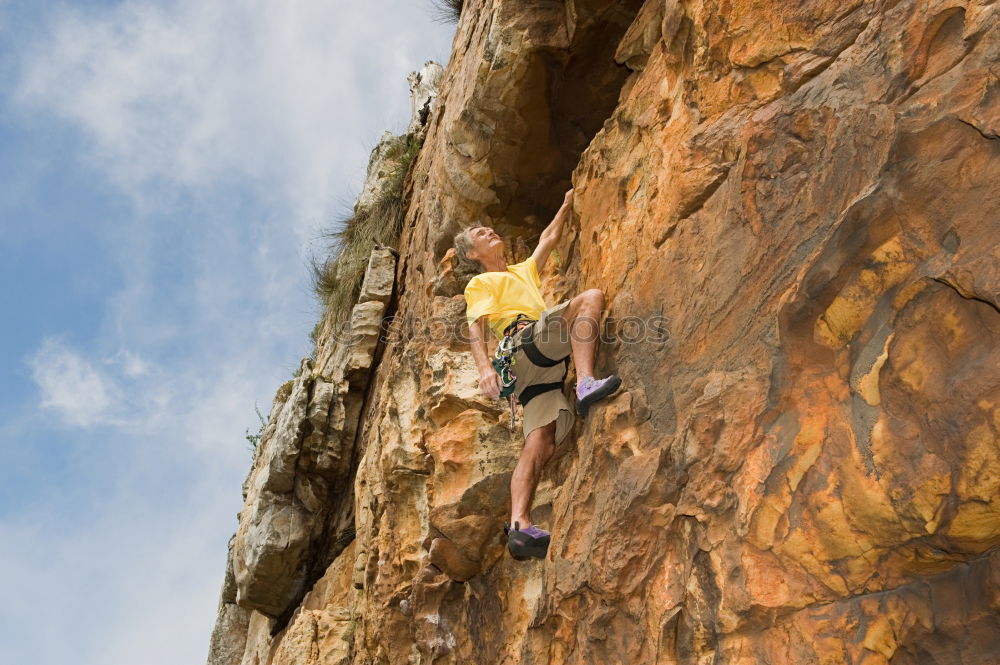 Similar – Female climber clinging to a cliff.