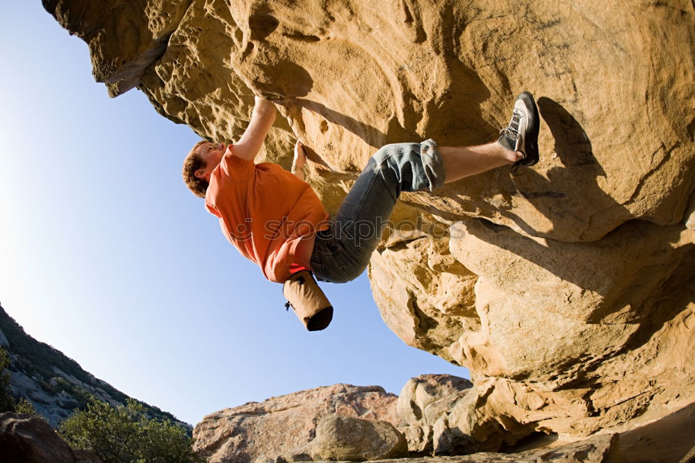 Similar – Female climber clinging to a cliff.