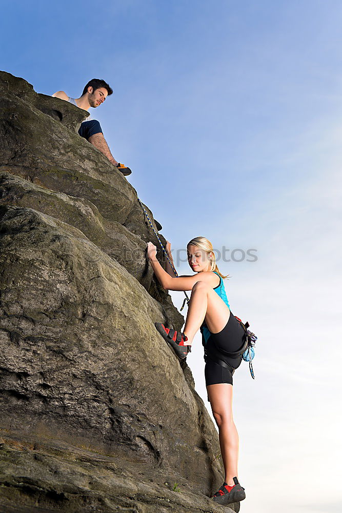 Similar – Image, Stock Photo Young couple rock climbing cliffs at the coast helping eachother