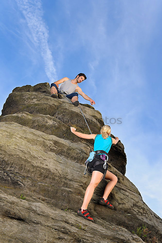 Similar – Image, Stock Photo Young couple rock climbing cliffs at the coast helping eachother