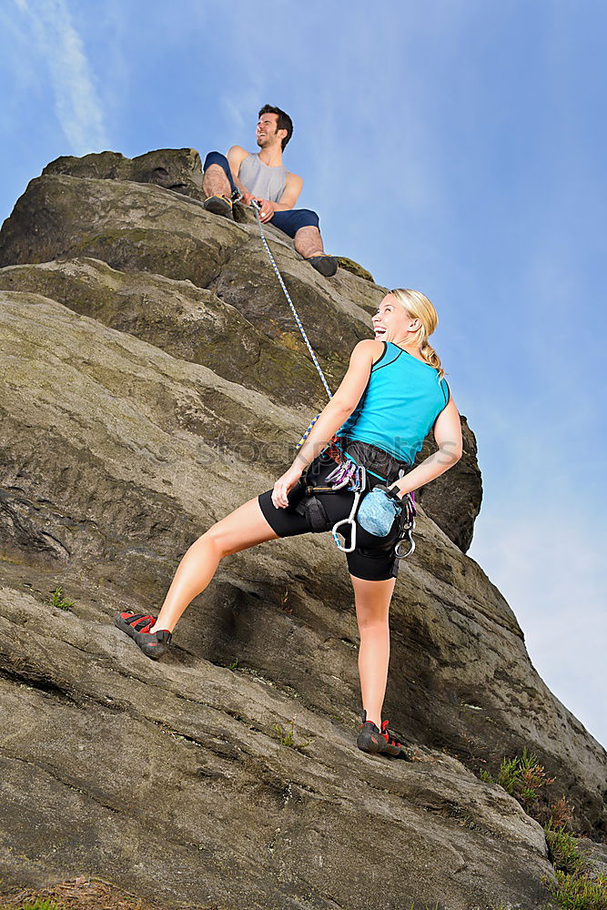 Similar – Image, Stock Photo Young couple rock climbing cliffs at the coast helping eachother