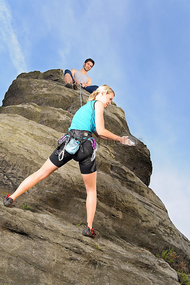 Similar – Image, Stock Photo Young couple rock climbing cliffs at the coast helping eachother