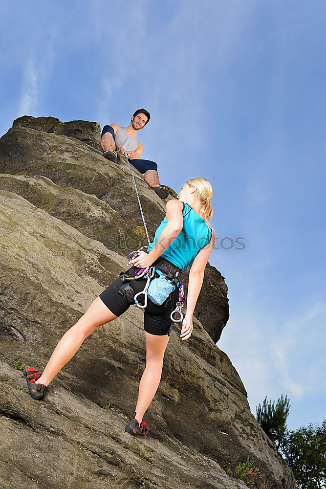 Similar – Image, Stock Photo Young couple rock climbing cliffs at the coast helping eachother