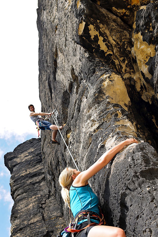 Similar – Young rock climber woman climbing the rock wall