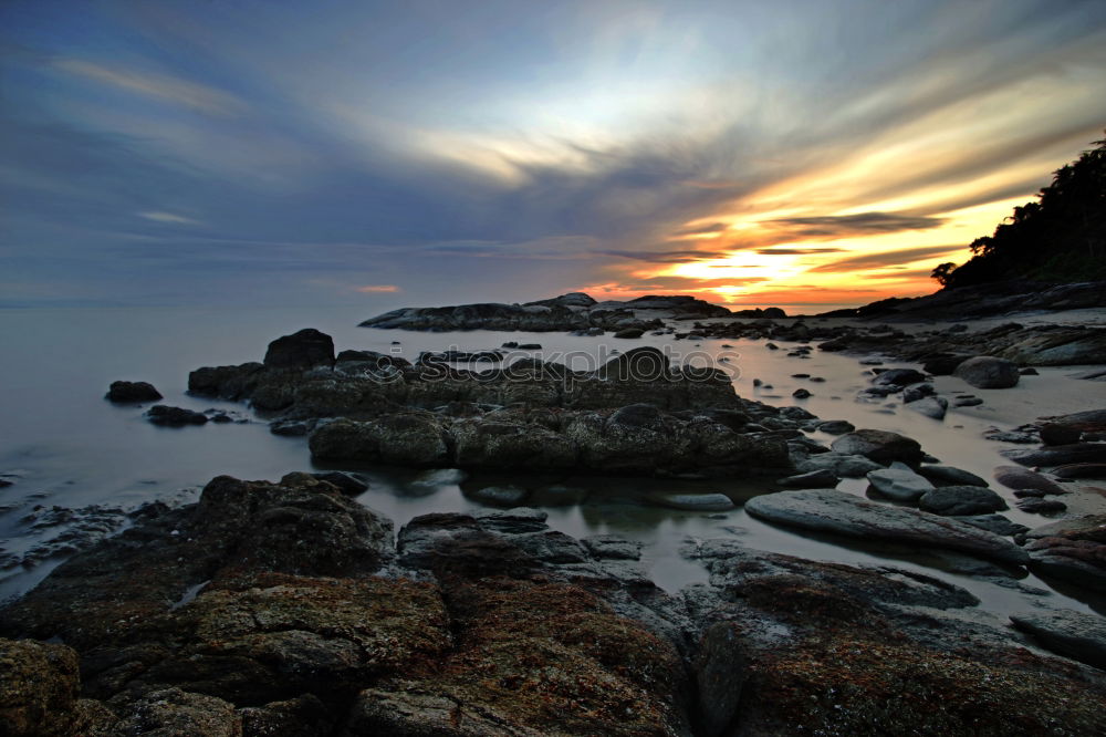 Similar – Rocks washed by the sea, with sky with sunset atmosphere