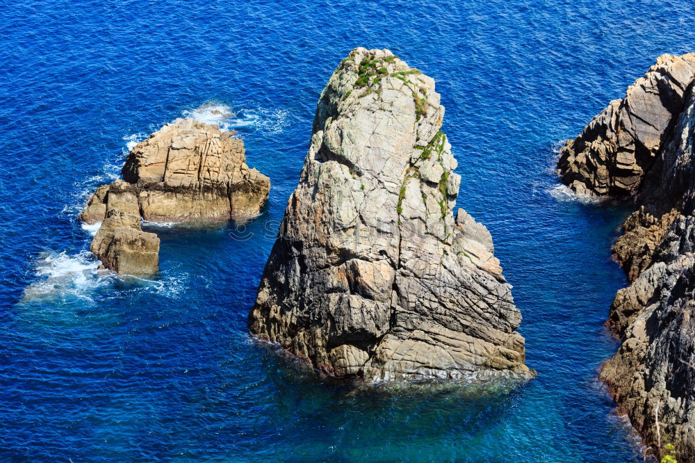 Similar – Rugged coast in the blue sea