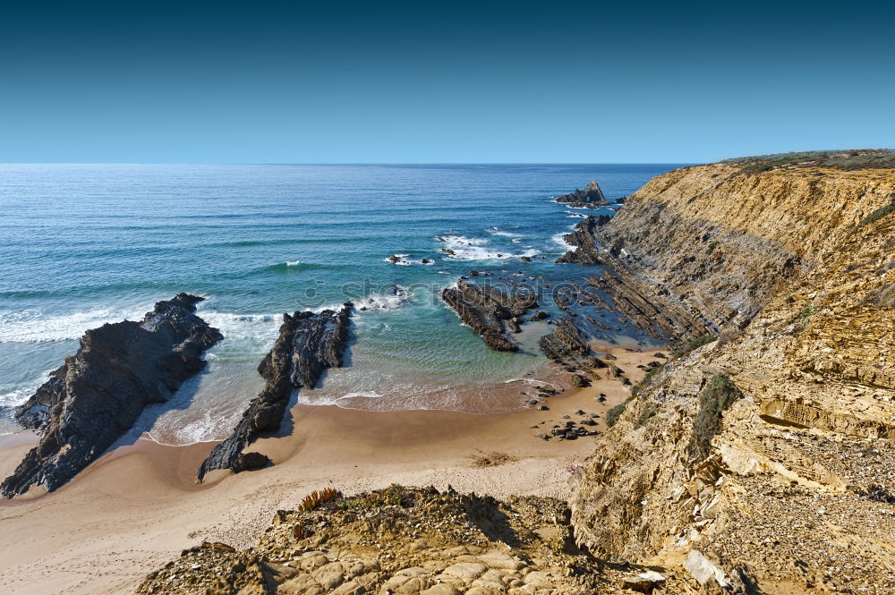 Similar – Beach landscape with cliffs