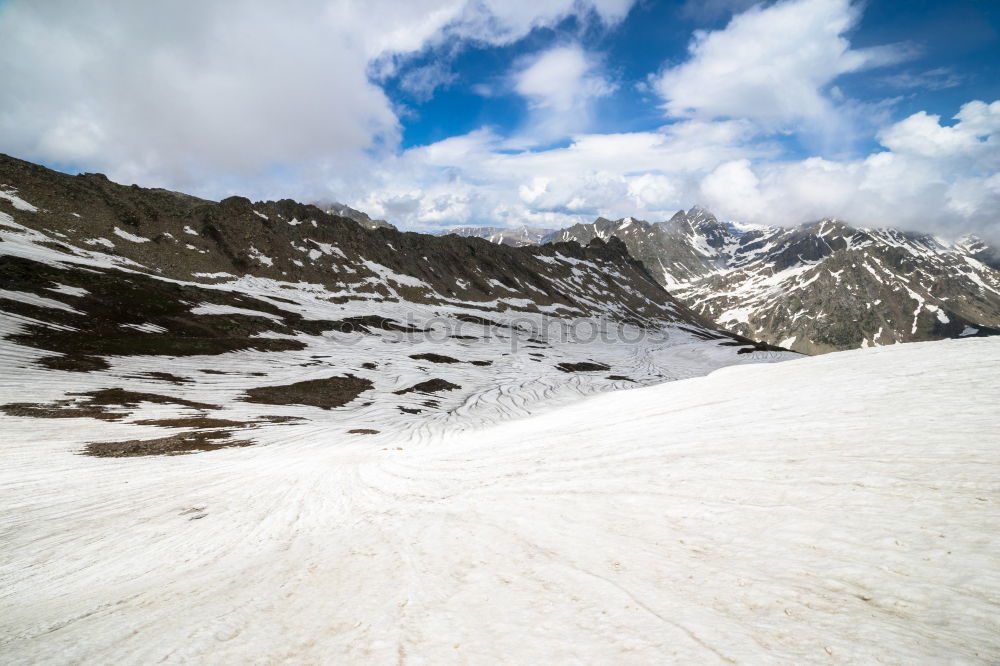 Similar – female hiker going up a mountain with snow.