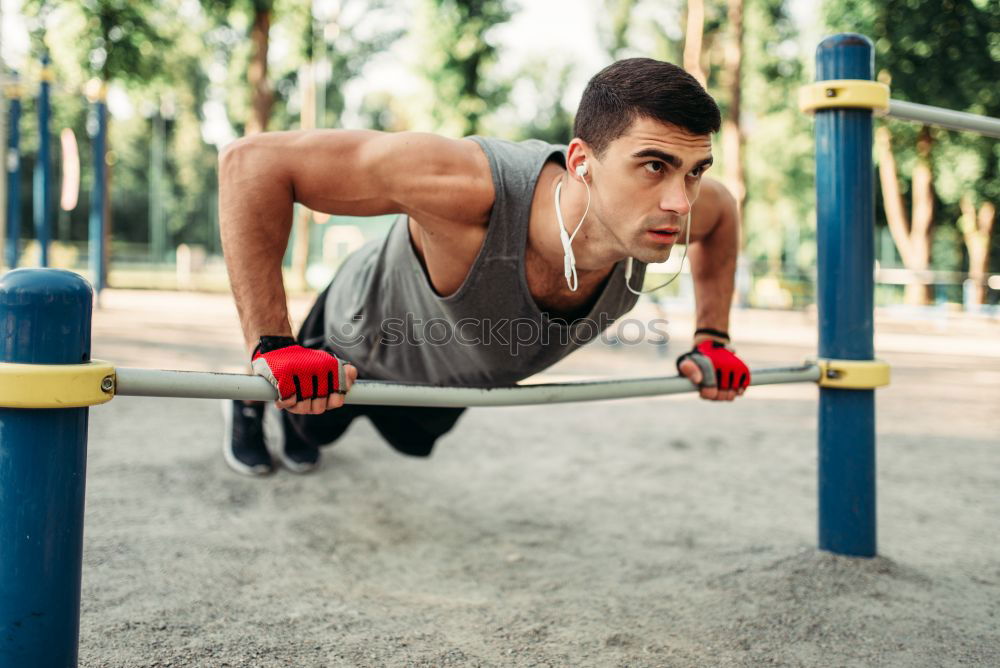 Similar – Athletischer junger Mann beim Vorbereiten und Kontrollieren von Gymnastikringen