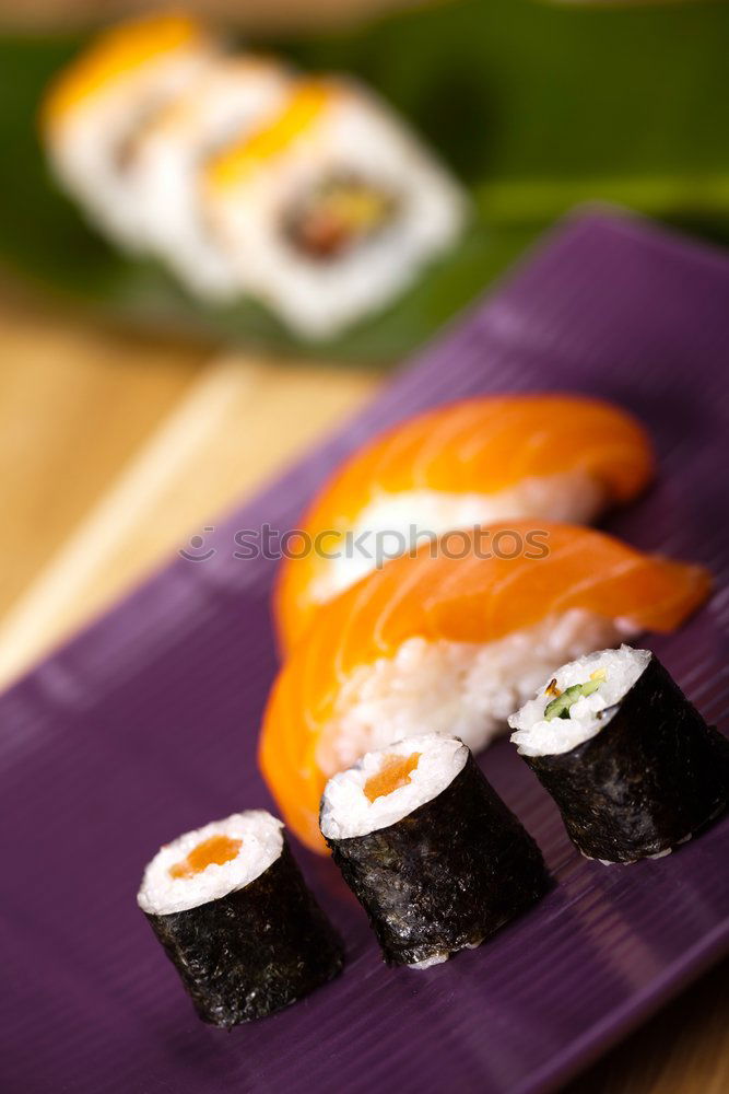 Similar – Female chef placing japanese sushi rolls on a tray