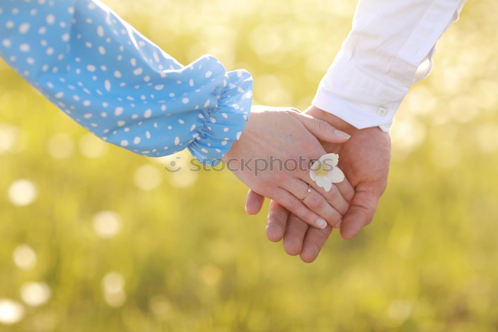 Similar – Baby girl holding finger of senior man hand