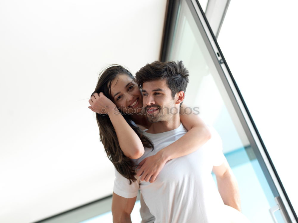 Similar – Happy loving couple. Happy young man piggybacking his girlfriend.