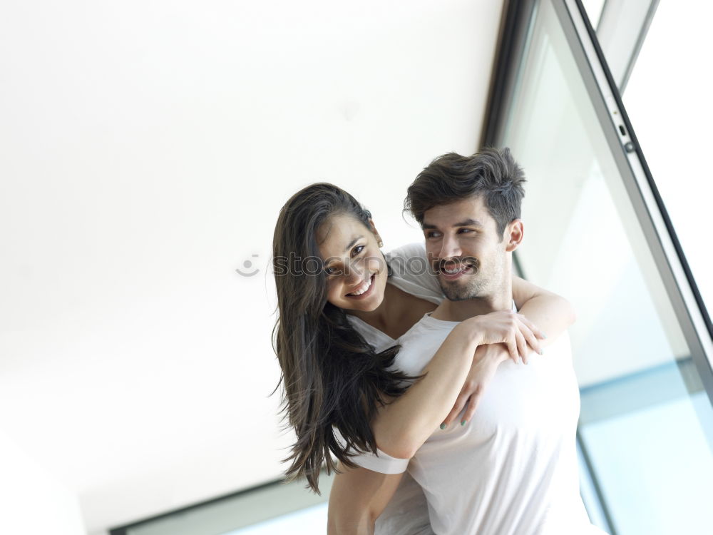 Similar – Happy loving couple. Happy young man piggybacking his girlfriend.