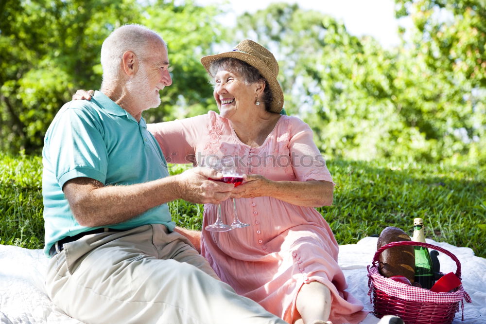 Similar – Image, Stock Photo 2 seniors in love are sitting on a bench in the vineyard and look into the Ahr valley. The man points to something.