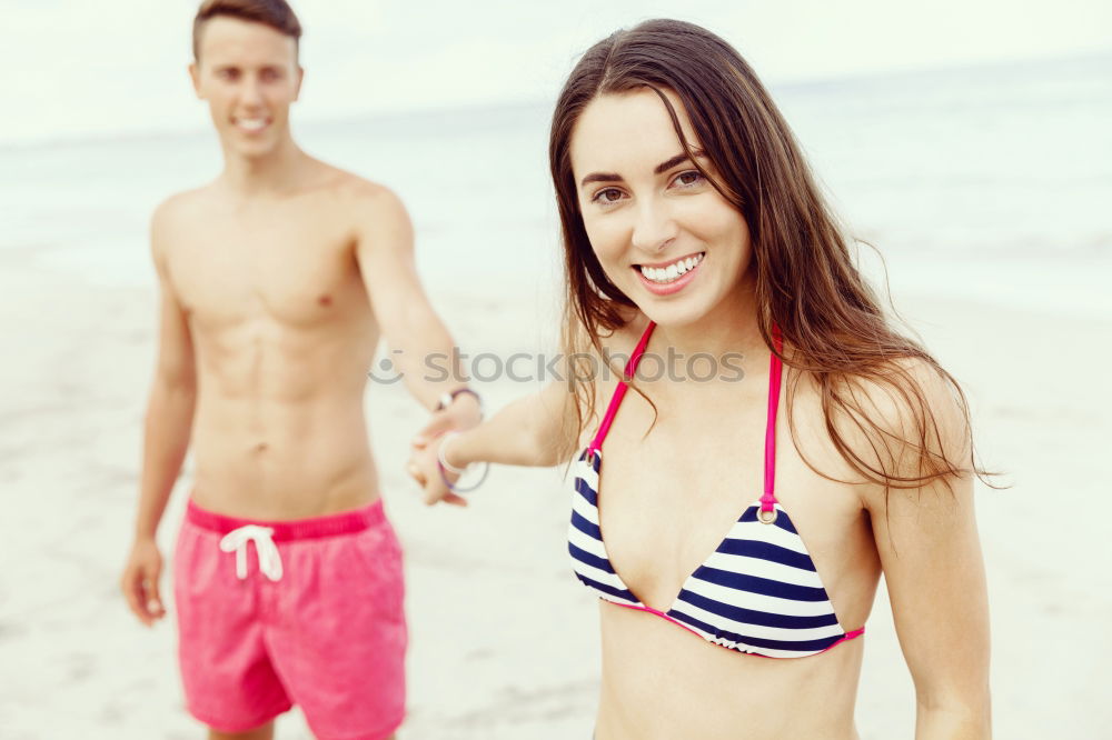 Similar – Close-up of young adult’s muscular bodies on the beach