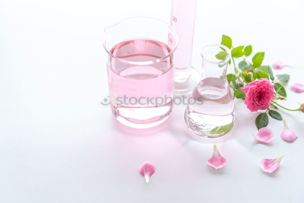 Image, Stock Photo Female hand holds bottle with pink lotion and flowers