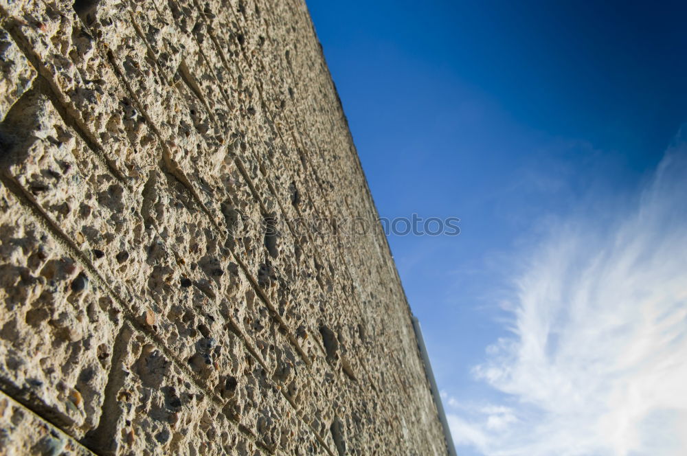 Facade of a church with cross in front of blue sky