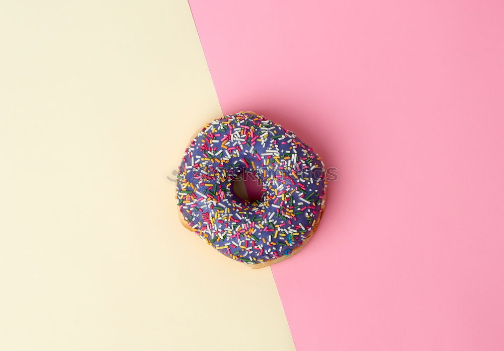 Sugar sweet donut on pink background