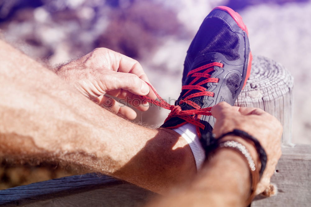 Similar – Image, Stock Photo Close-up shot of man tying running shoes with foot on the bench. Getting ready before jogging. Going in for sports, healthy lifestyle