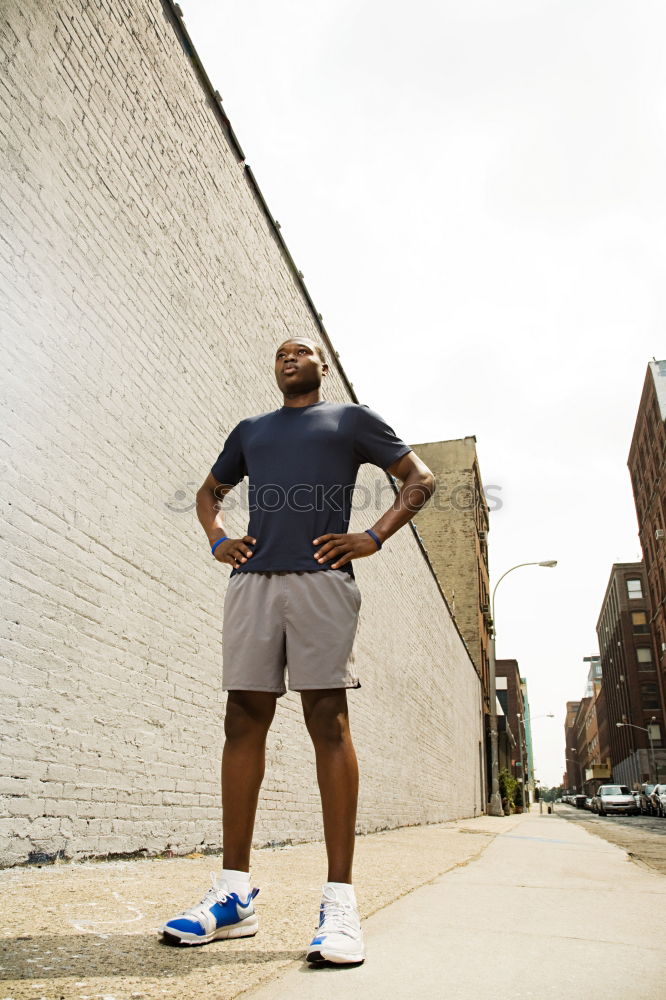 Similar – Image, Stock Photo Black man running upstairs outdoors listening to music with white headphones.