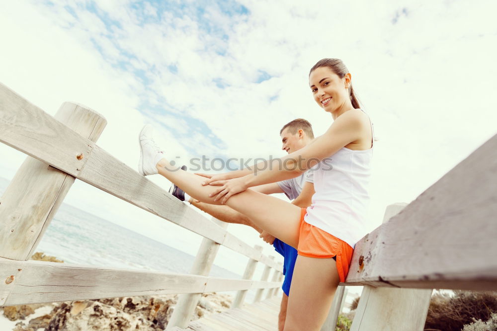 Similar – Adult fitness couple doing exercise together on beach