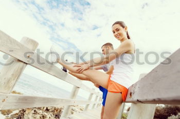 Similar – Adult fitness couple doing exercise together on beach