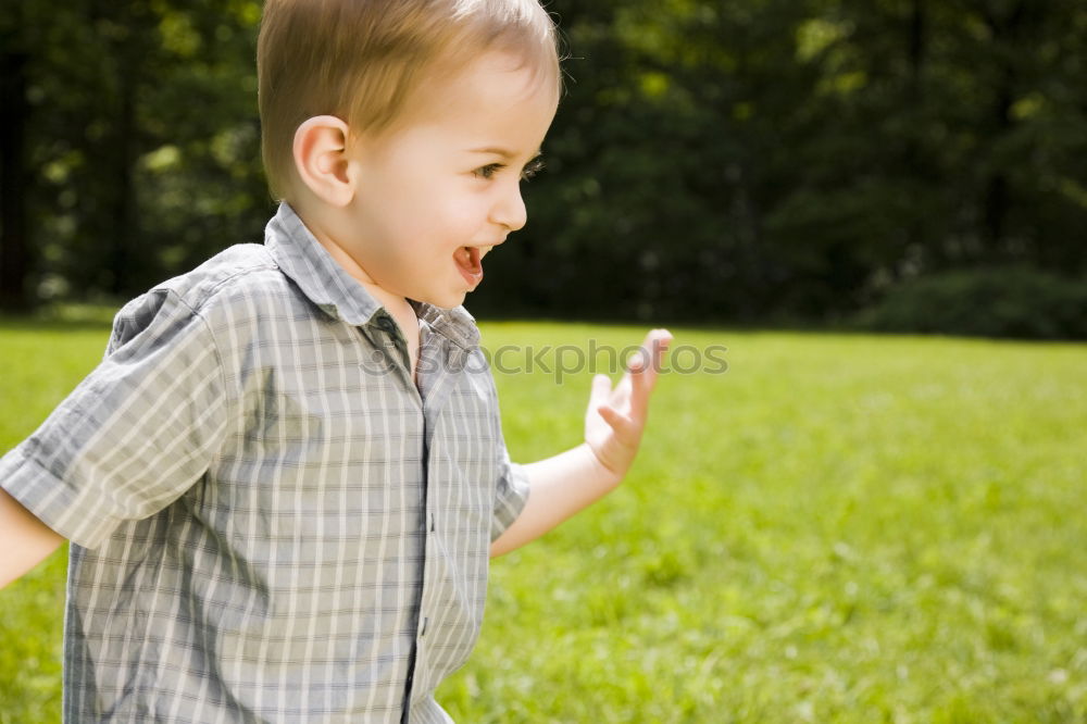 Similar – Funny, funny, cheerful, happy, funny blonde girl outside in the garden, looks up and sticks out her red tongue. Little joker is fooling around, fun with twisted eyes in nature, in the park with flowers and trees.