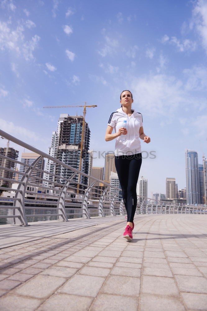 Similar – Image, Stock Photo Young couple running on a seafront promenade